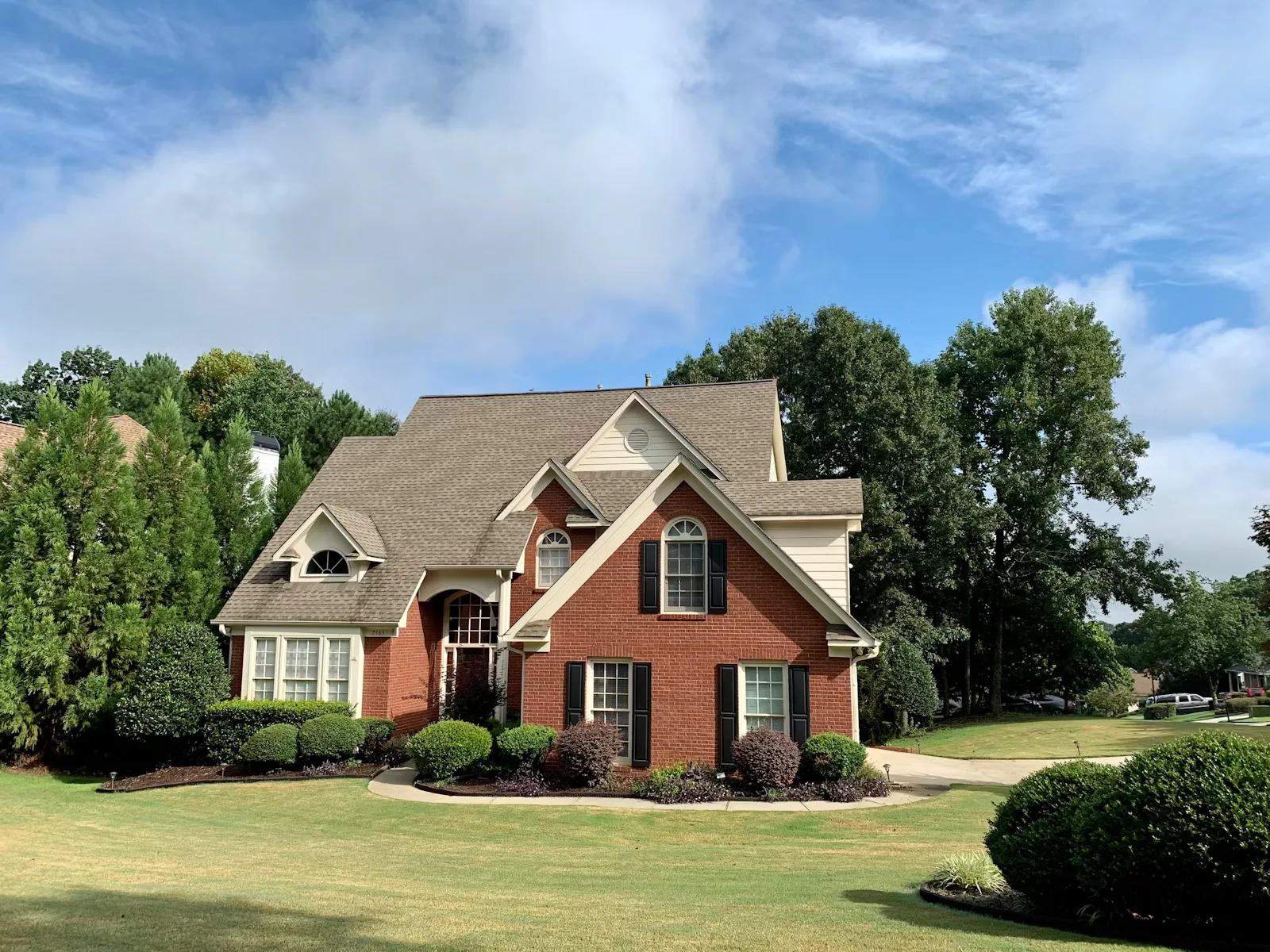 A home exterior surrounded by trees on a clear day